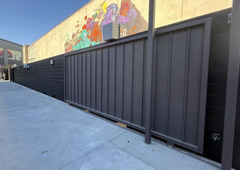 Commercial exterior painted fence and block wall with mural
