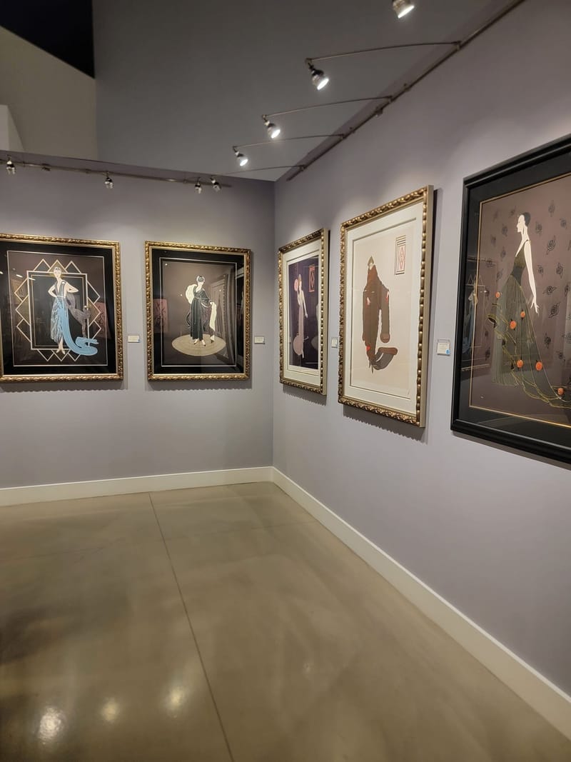 Art gallery interior with lavender painted walls and framed artwork