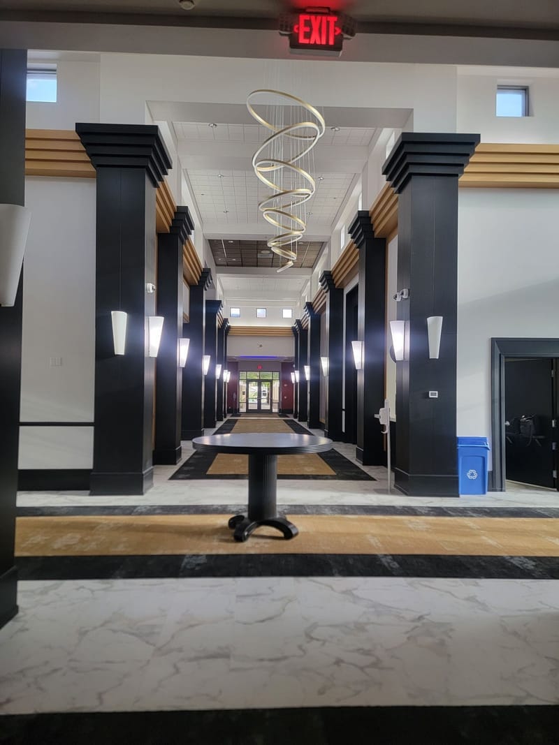 Grand commercial lobby with black and gold painted columns