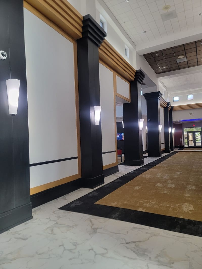 Commercial hallway with painted black columns and white wall panels